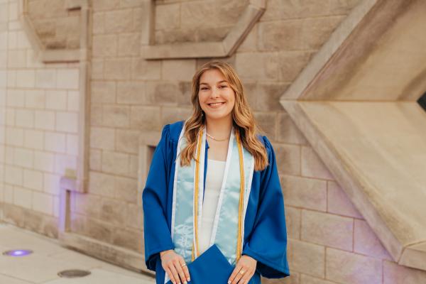 a photograph of Ashley Grospitch in their graduation robe