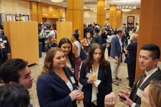 UK MHA students speaking with guests at a reception