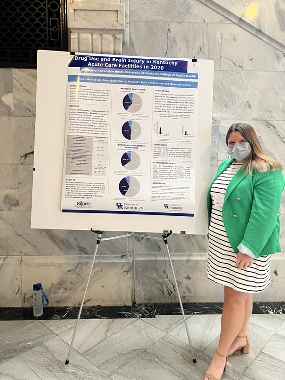 a photograph of Grace Bush next to their poster presentation