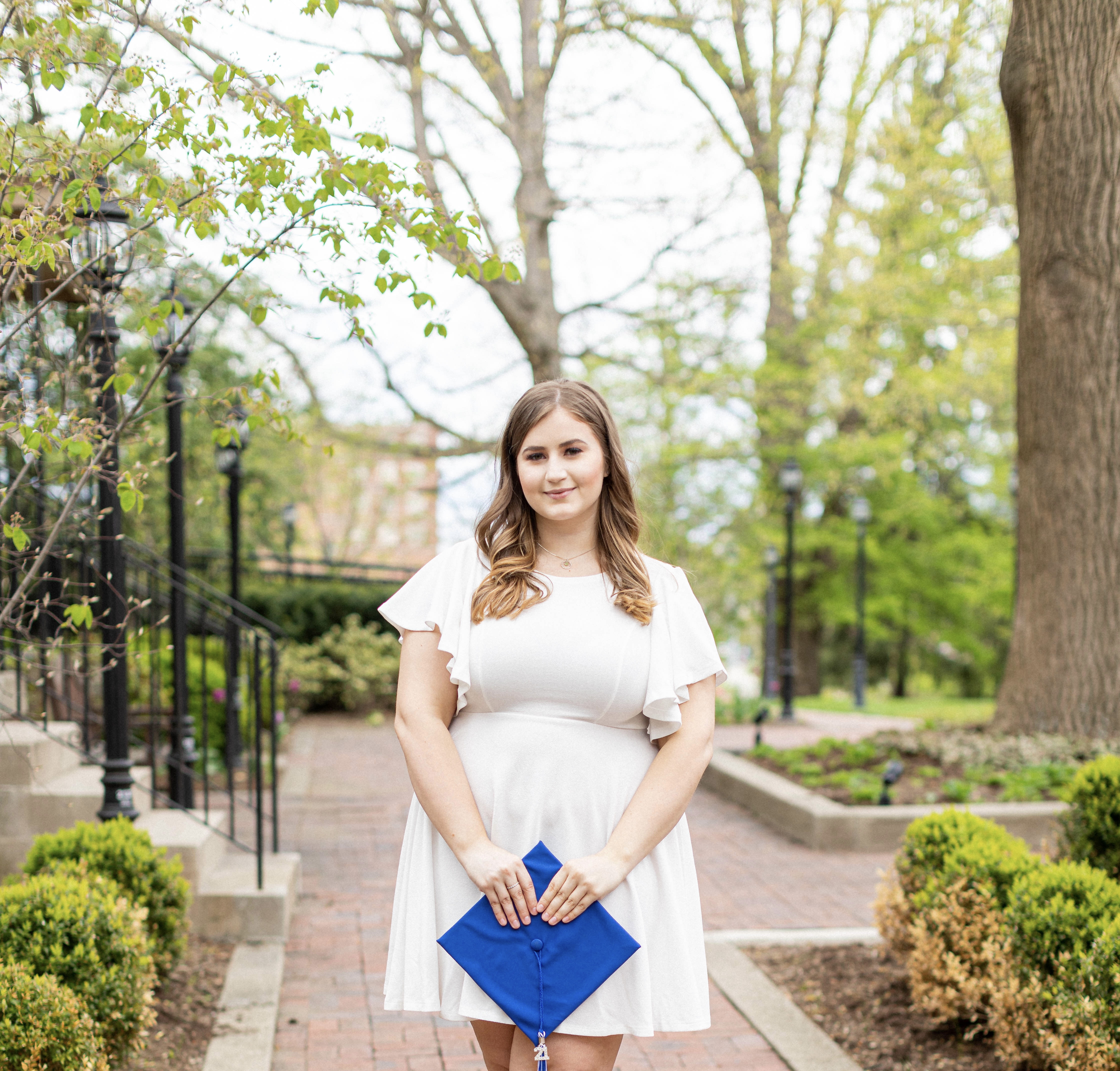 a photograph of Kelsey Gatton posing with her graduation cap