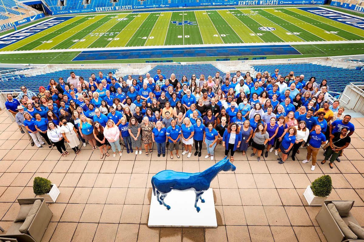 a group photograph of the student success team at a reception event at Kroger Field