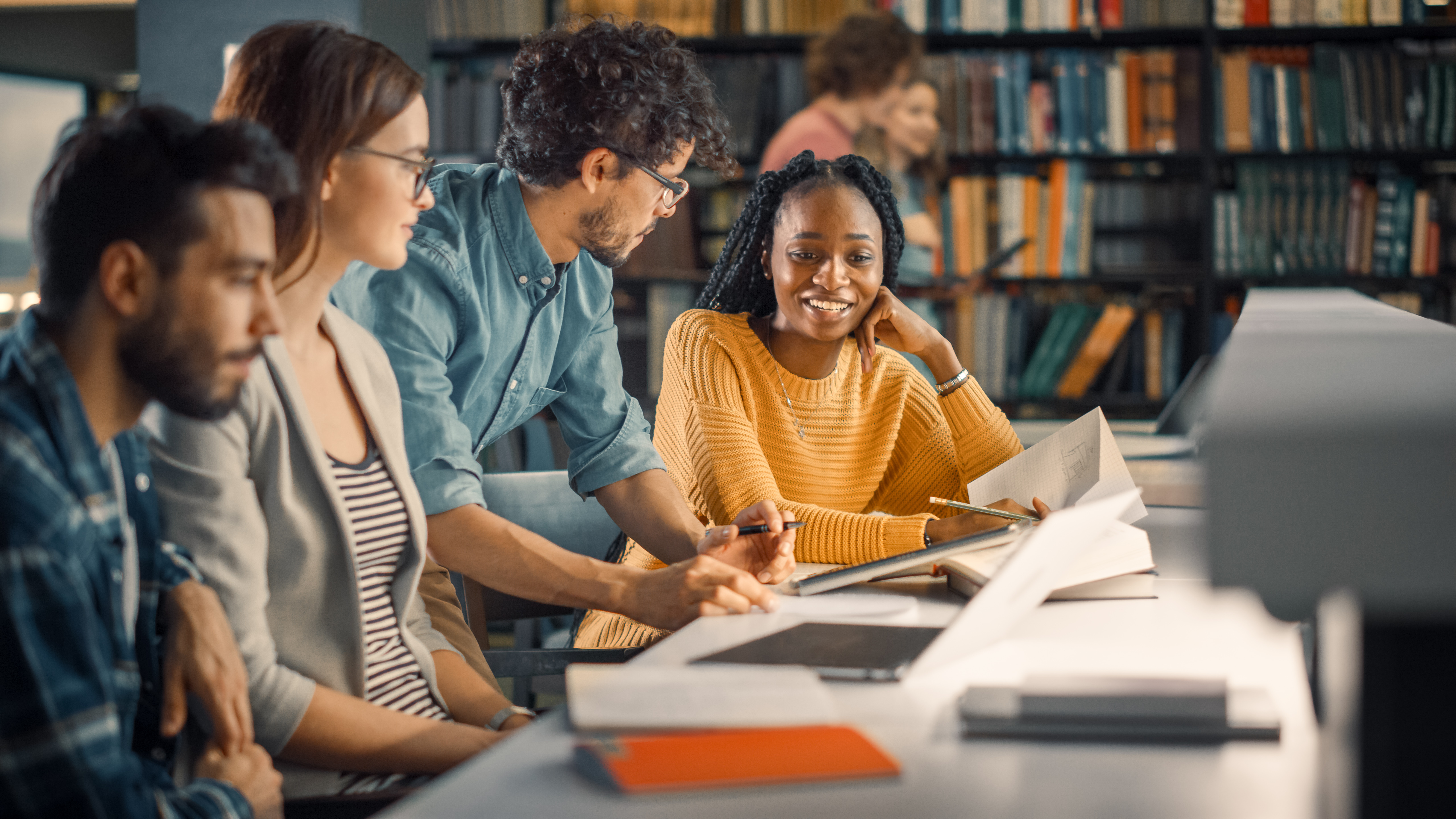 a stock photograph of students working together on homework