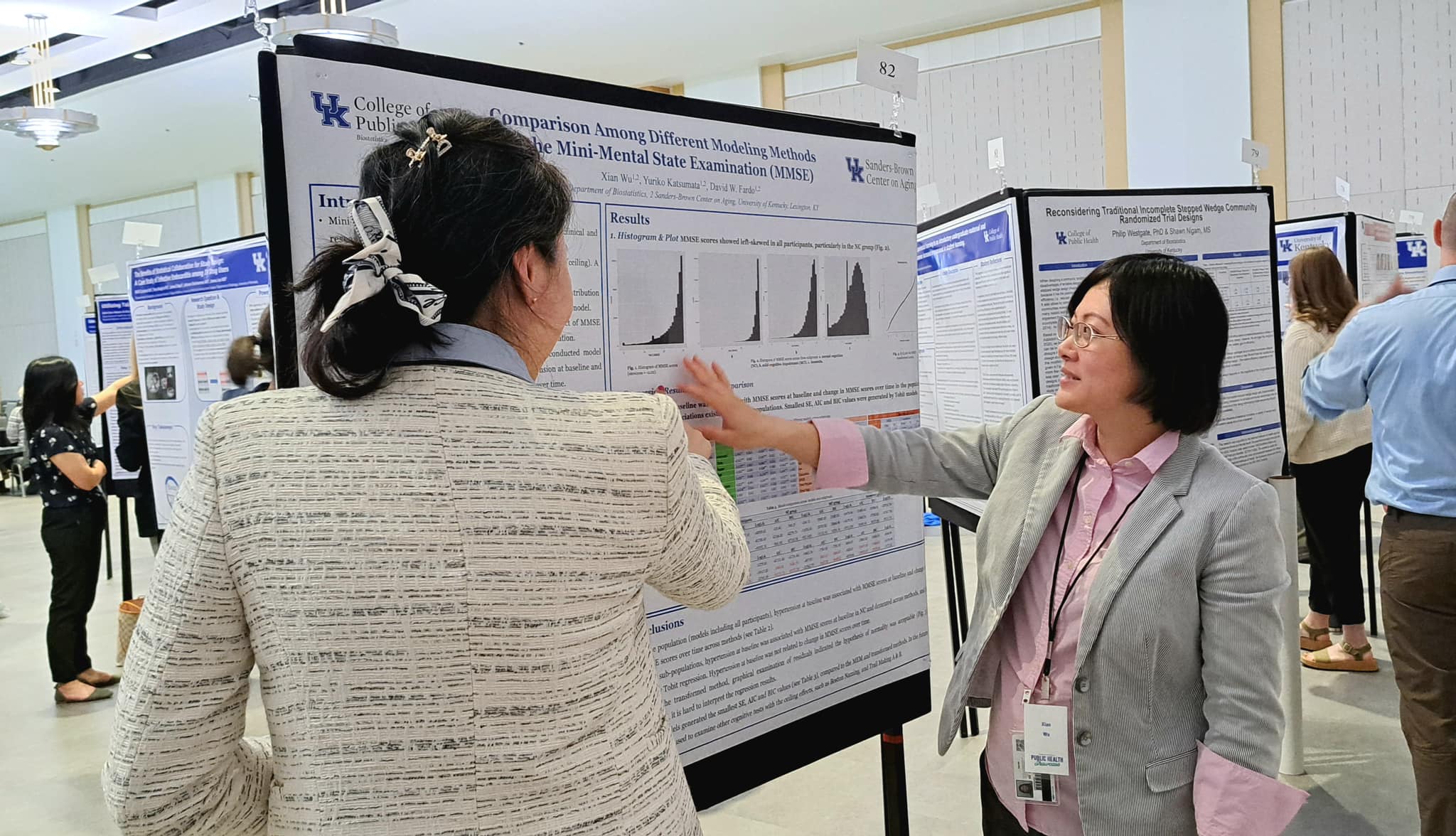 Students standing in front of a research poster discussing findings