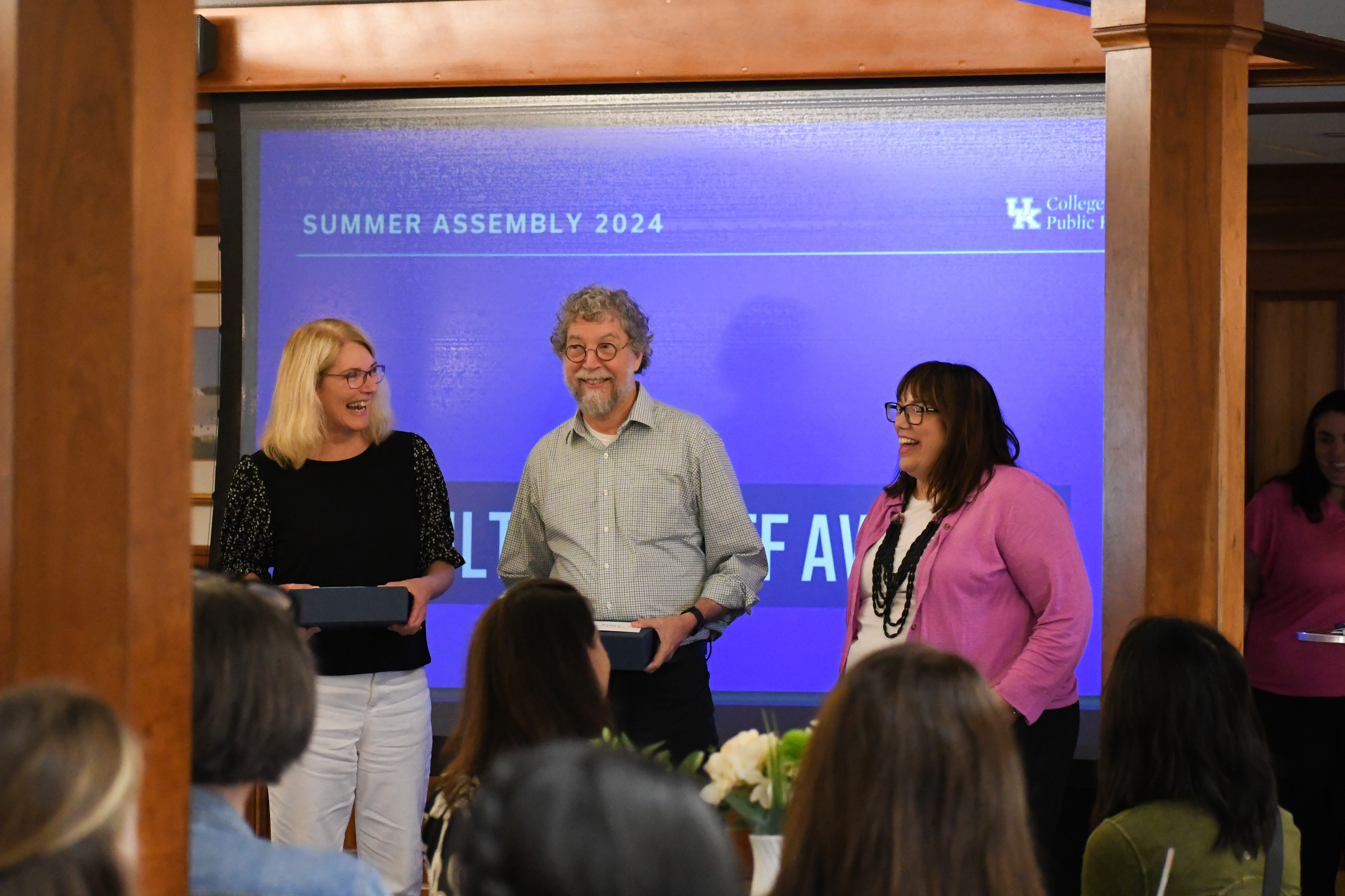 a photograph of CPH faculty getting an award from Heather Bush