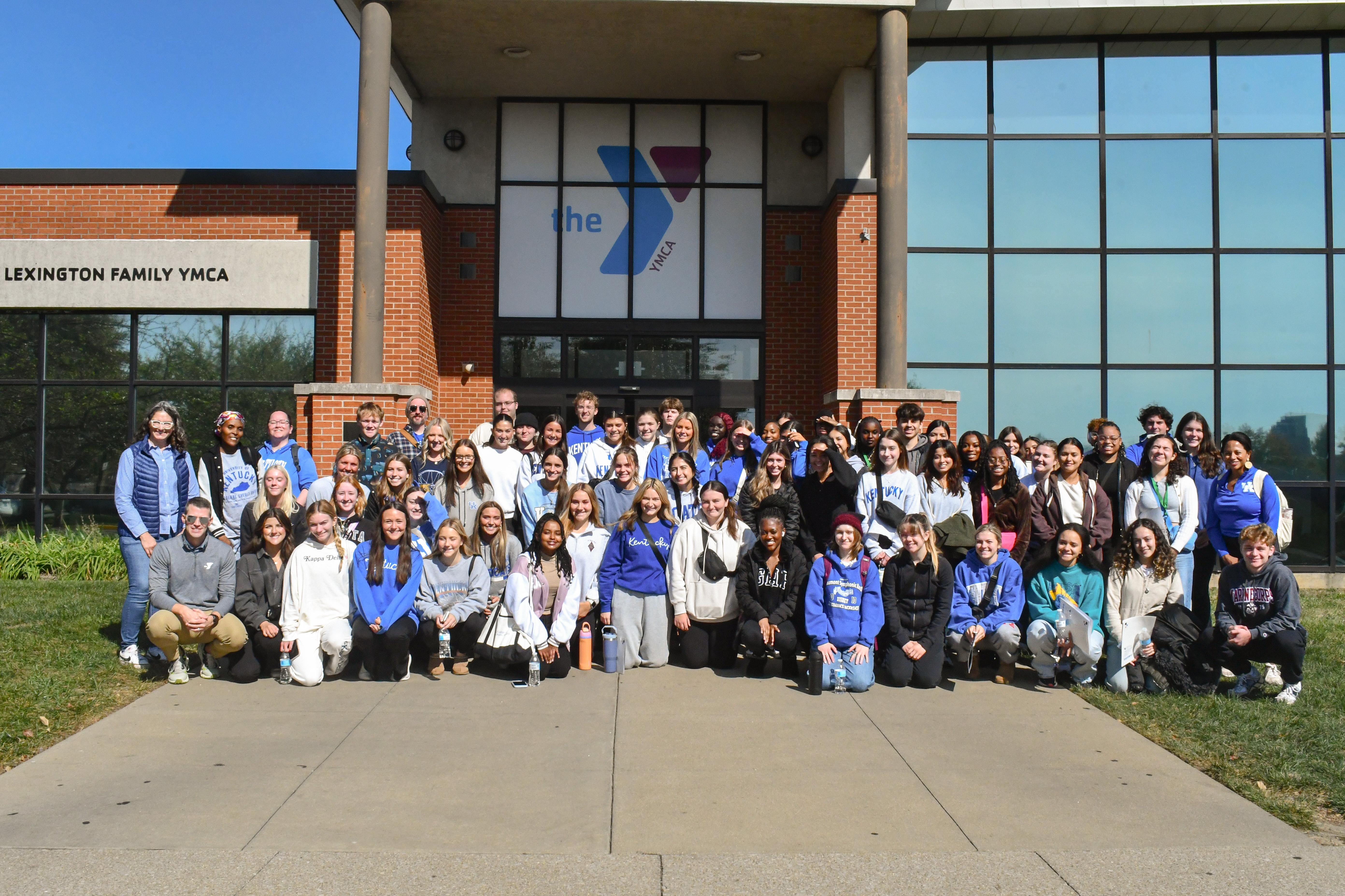 a photograph of College of Public Health students posing outside a YMCA