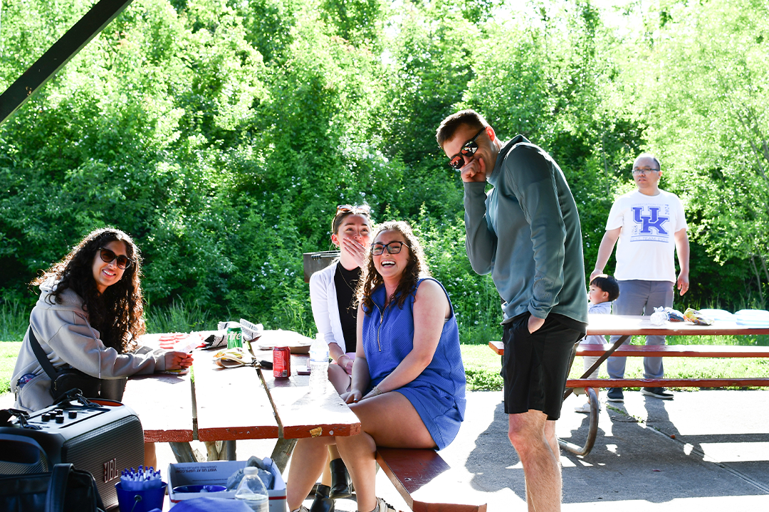 a photograph of college of public health students in a park pavilion at an event