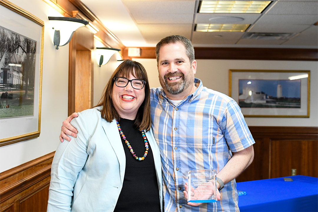 a photograph of Dave Fardo holding their award next to Heather Bush