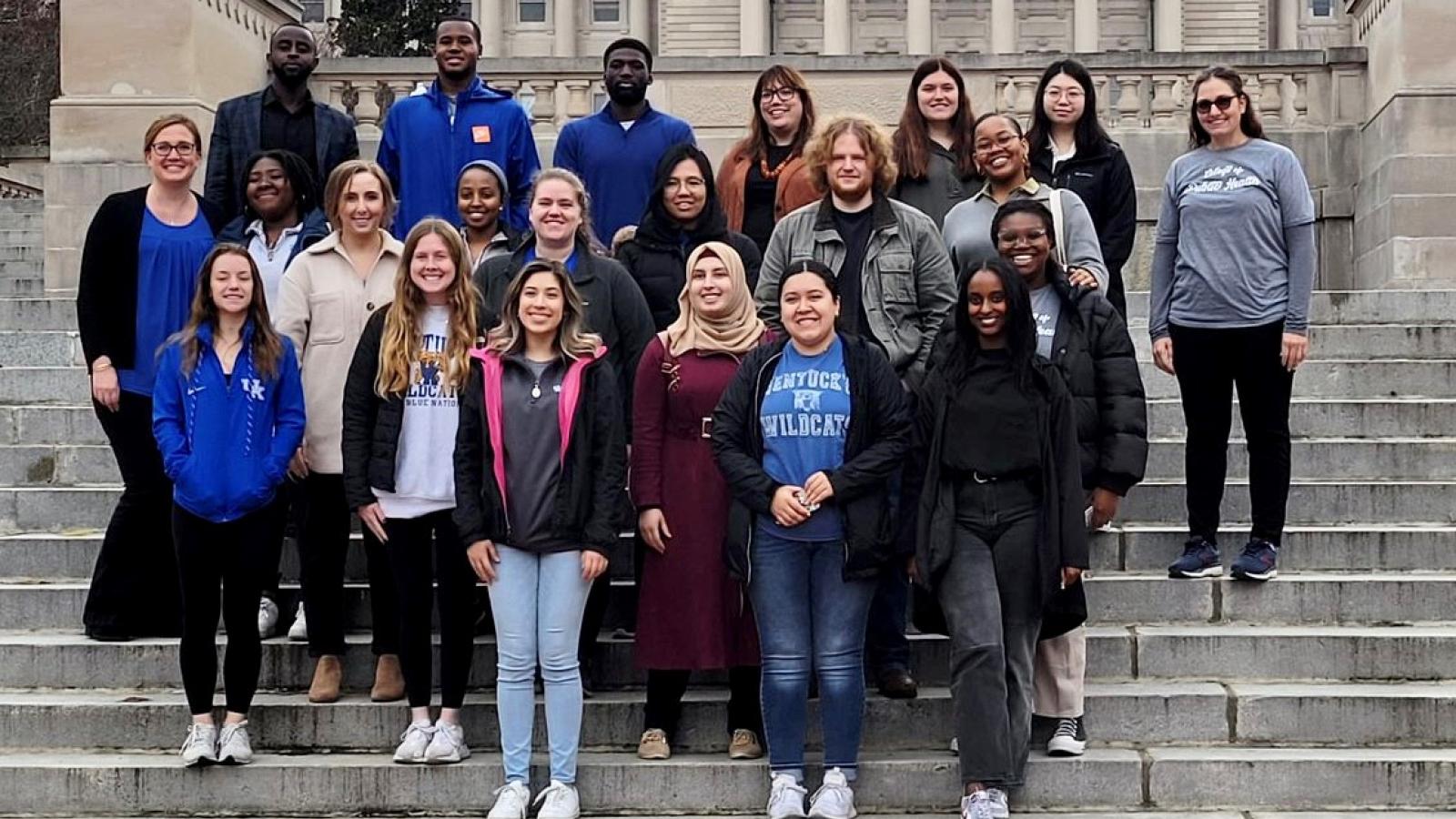 a photograph of a group of University of Kentucky College of Public Health students in front of the state capitol in Frankfort, Kentucky