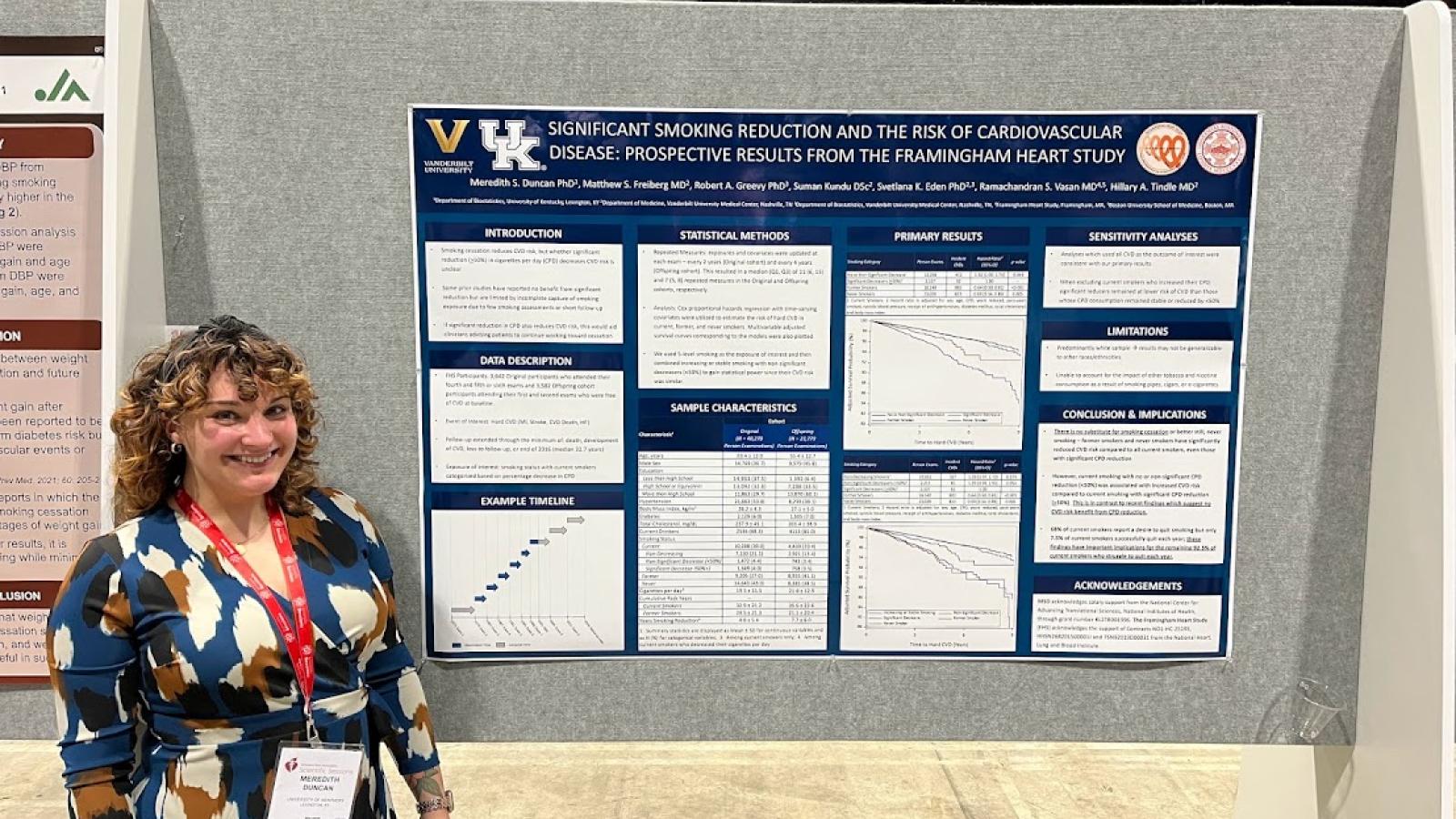 a photograph of Dr. Meredith Duncan standing in front of a research poster