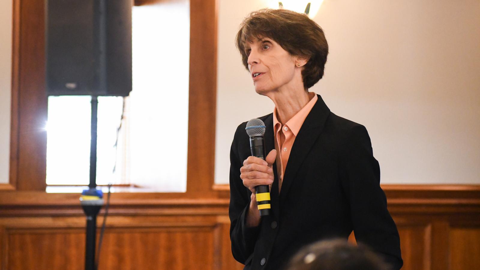 a photograph of Martha Riddell speaking at an event
