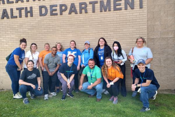 a photograph of a group of students posing outside the Breathitt County Health Department building