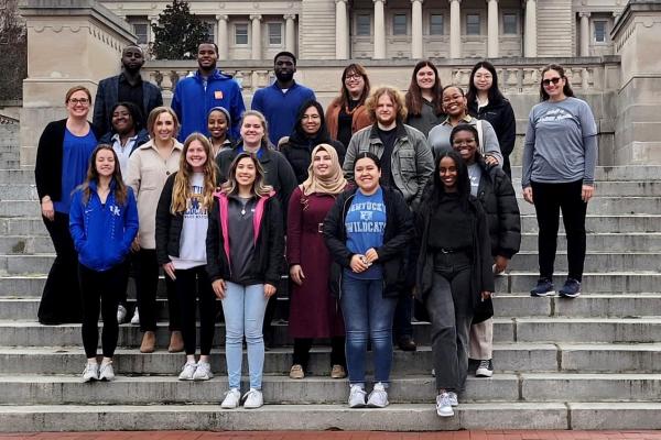 a photograph of a group of University of Kentucky College of Public Health students in front of the state capitol in Frankfort, Kentucky