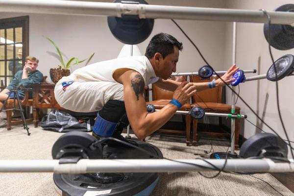 Jockey Rafael Bejarano balances in riding position on an upside-down BOSU ball while SMRI researchers test his reaction time to a series of lights