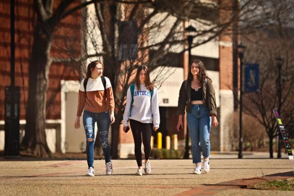 a photograph of three University of Kentucky students walking on campus
