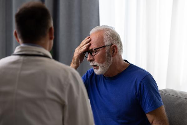 Doctor physician talking to distressed, sad senior patient having bad diagnosis, disease or health problem. Elderly medical health care concept