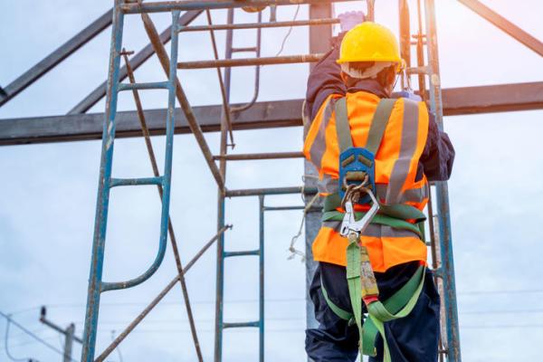 a photograph of someone climbing a ladder in construction gear