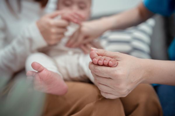 a photograph of a baby getting a medical exam