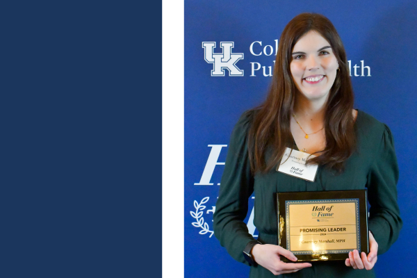 a photograph of Courtney Marshall holding their award