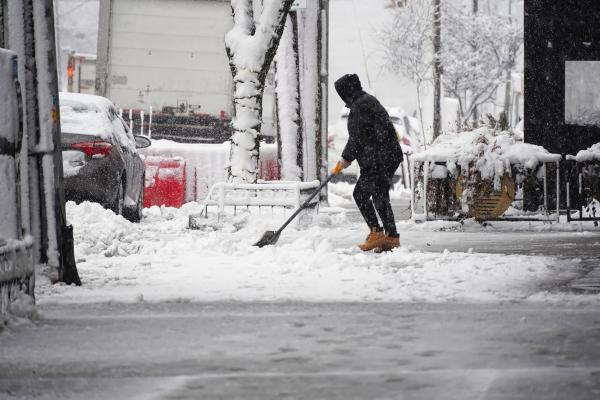 a photograph of someone shoveling snow