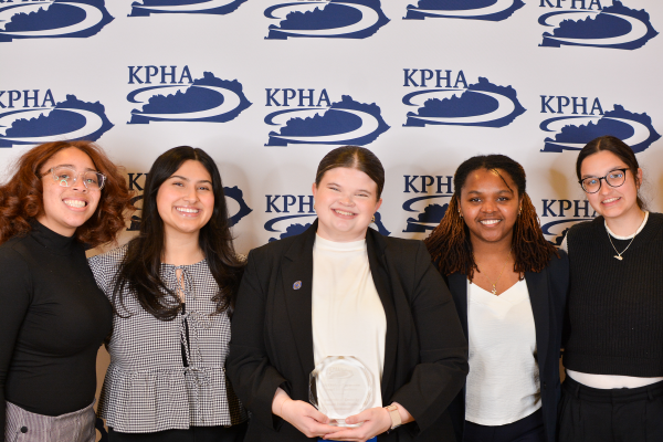 a photograph of the UKSPHA posing with their award