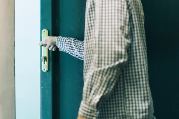 a stock photograph of someone opening a door