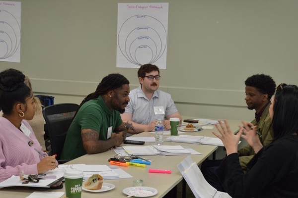 a photograph of people sitting around a table in a classroom during the Kentucky Launches Injury-Free Academy