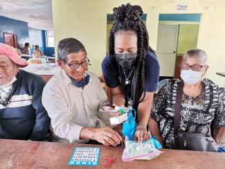 a photograph Dr. McWhorter handing out sanitation supplies during a game of Bingo