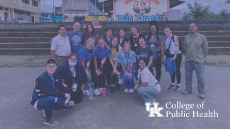 a photograph of students and faculty in Ecuador, with the College of Public Health lockup in the right corner
