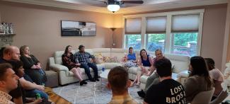 a photograph of students sitting in a living room with Dr. Min-Woong Sohn