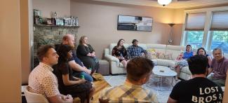 a photograph of students sitting in a living room with Dr. Min-Woong Sohn