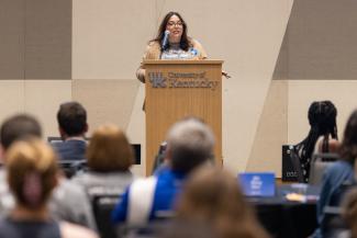 a photograph of Dean Heather Bush speaking at a podium at the Pump it Up Event