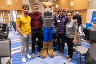a photograph of The Wildcat mascot with a group of College of Public Health members