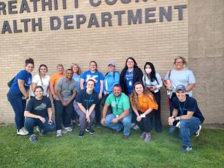 a photograph of a group of students posing outside the Breathitt County Health Department building