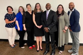 a photograph of six College of Public Health alumni with Heather Bush included