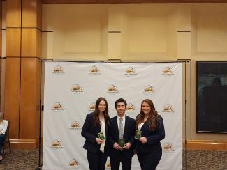 Pictured is UK MHA student case competition team holding their awards