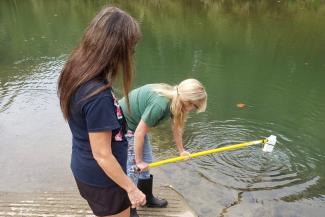 Community partners Nina McCoy and Debi Sexton conduct sampling activities