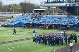 a photograph of Dean Heather Bush throwing out first pitch at Kentucky Proud Park