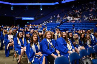 Public health students at commencement ceremony in graduation regalia at Rupp Arena