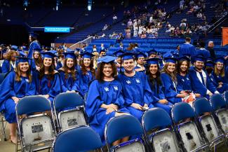 Public health students at commencement ceremony in graduation regalia at Rupp Arena