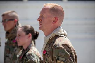 Maj. Hincks pictured standing in formation with other officers