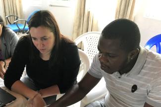 Charlene Siza assisting Ministry of Health staff with updating a transmission chain in Goma Democratic Republic of the Congo during the 2018 Ebola response