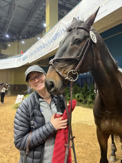 a photograph of Team member Allison Kroph helping with UK horses at nationals