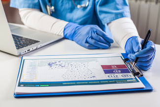 a photograph of a nurse mapping out disease cases on a clipboard