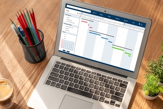 a stock photograph of a laptop computer and a stack of pencils