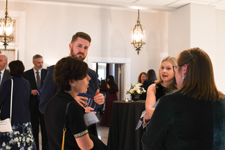 a photograph of antendees socializing