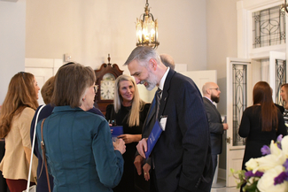 a photograph of antendees socializing