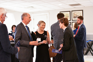 a photograph of atendees socializing