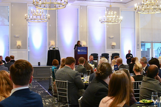 a photograph of someone speaking at the event
