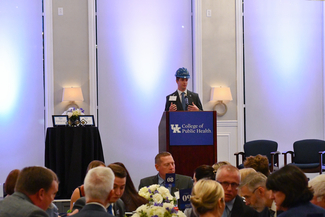 a photograph of Logan Smart speaking at the event