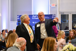 a photograph of two attendees laughing